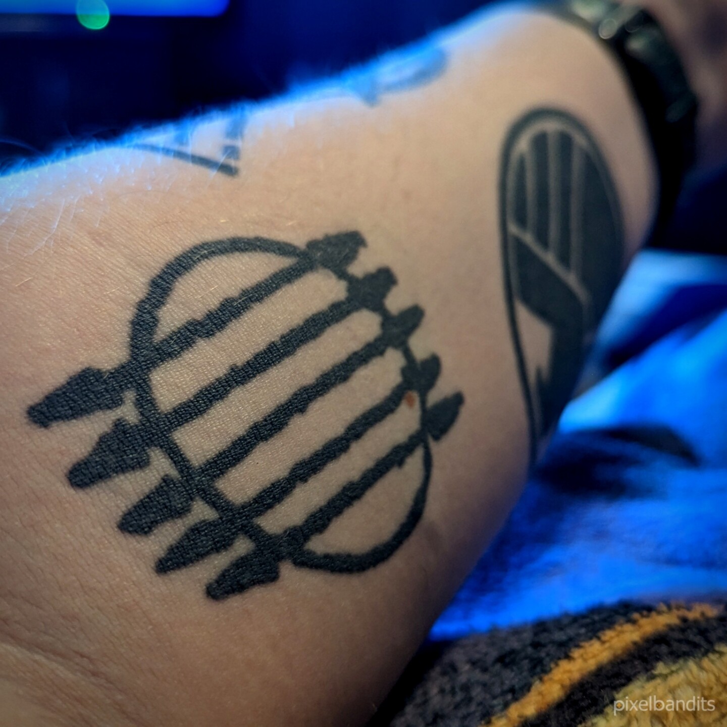 A Terry Pratchett tattoo by Di! City Watch badge with some lilac, from the  city of Ankh-Morpork, on Discworld, floating through space on ... |  Instagram