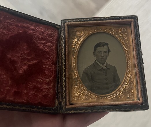 An old daguerreotype with the picture of a young boy
