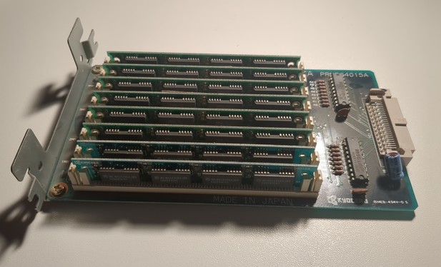 a rectangular pcb with a cover on one and a connector on the other end. most if the space is taken up by 8 rows of SIMM memory modules