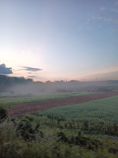 morning fog, sunrise in the back and small fields in the front