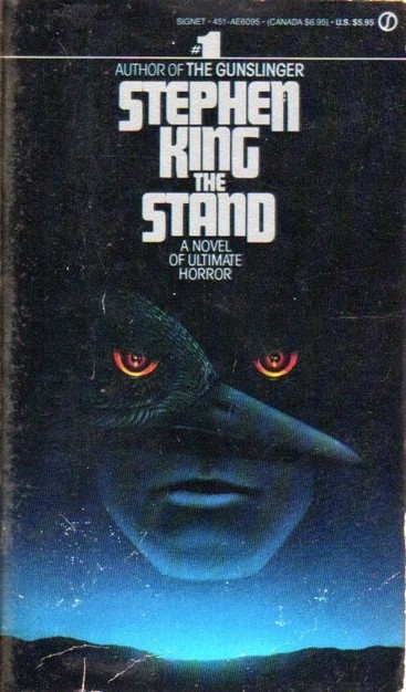 A book cover -- mostly black, with a starry sky and landscape near the bottom. In the center is an image of a man with red eyes, and superimposed over it is an image of a crow. Both the man and the crow share one of the red eyes.
The title text reads:
Author of The Gunslinger
Stephen King
The Stand
A Novel of Ultimate Horror