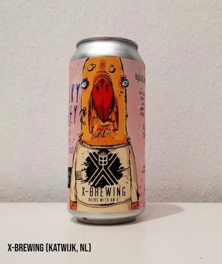A yellow, orange, and pink 440 ml can of Milk Stout by X-Brewing from Katwijk, The Netherlands.