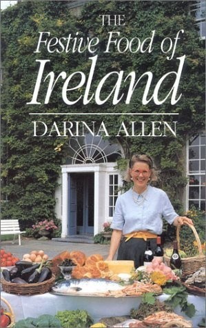 A book cover showing a woman standing in front of a table filled with food. Behind her is an ivy-covered building.

The type (in white letters) reads:
THE
Festive Food of
Ireland
___________
DARINA ALLEN