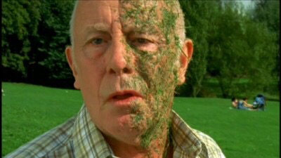 Screenshot from One Foot In The Grave, in which Victor has half his face covered in grass cuttings.