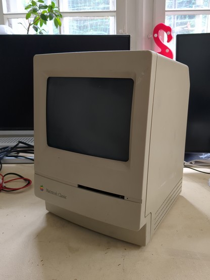 a macintosh classic computer on a desk