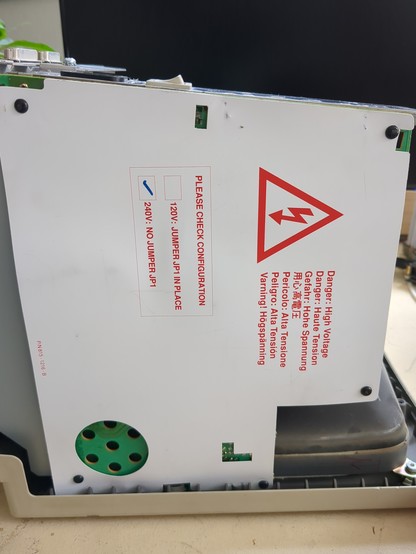 a white plastic sheet on the back of the power/crt board with a high voltage warning in red