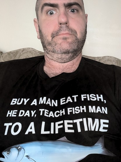 me wearing a shirt with a fish on it that says 