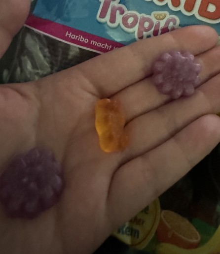 Three gummies two of them fruits and another a bear