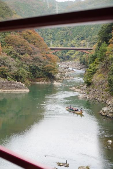 Blick aus dem Zug ins Tal mit Kahn im Katsura-Fluss